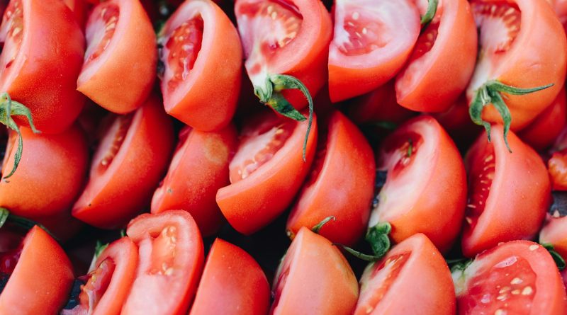 red sliced tomato in close up photography